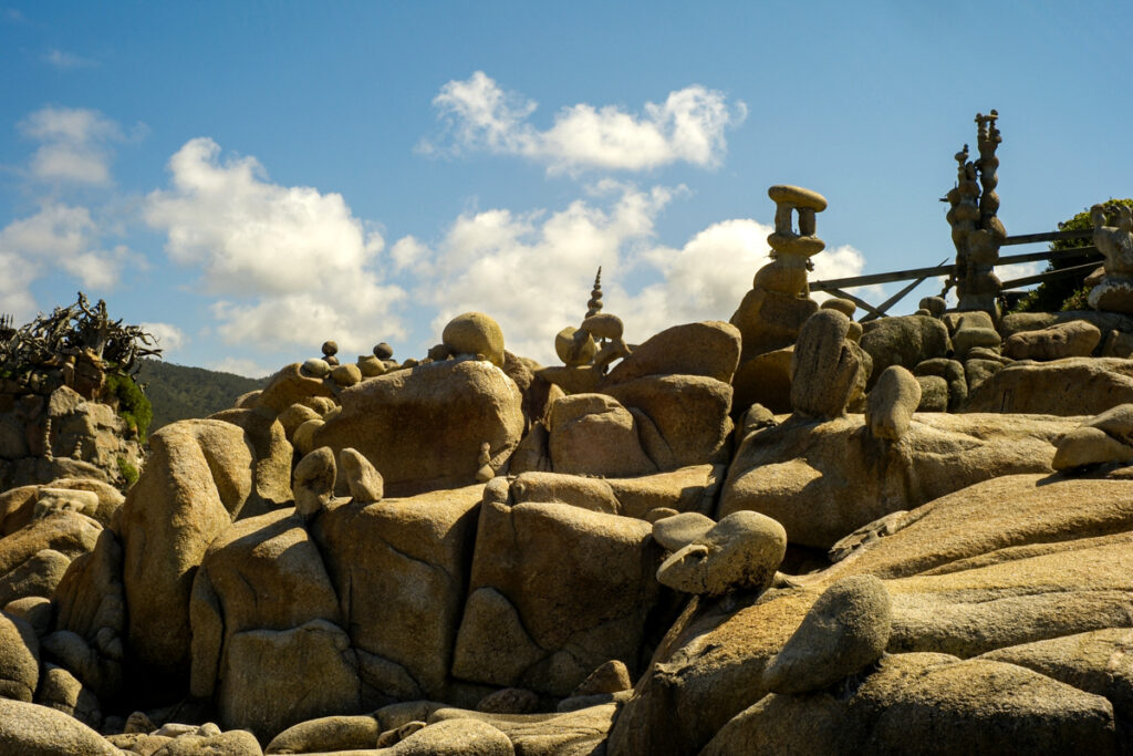 Sculpted stone landscape and spires created by Manfred Gnädinger along Camelle’s rocky shoreline.