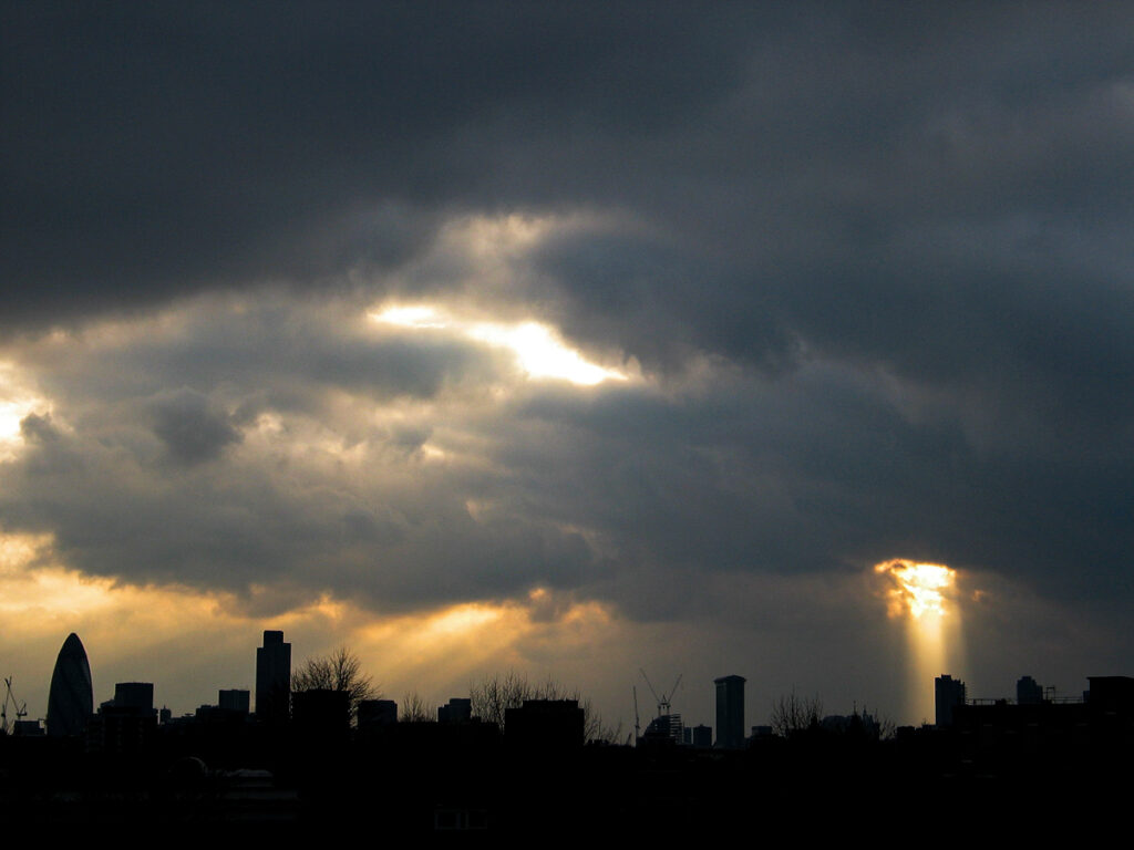 City of London skyline from Hackney on Friday 2 January 2004 at 15:41, showing The Gherkin, Tower 42, and One Canada Square beneath a dramatic cover of stratocumulus and nimbostratus