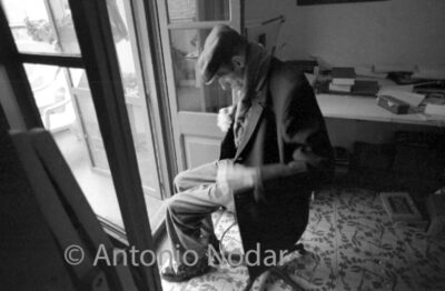 Carlos Moro, seated by an open door, looking down, in a quiet moment at his home in Barcelona.